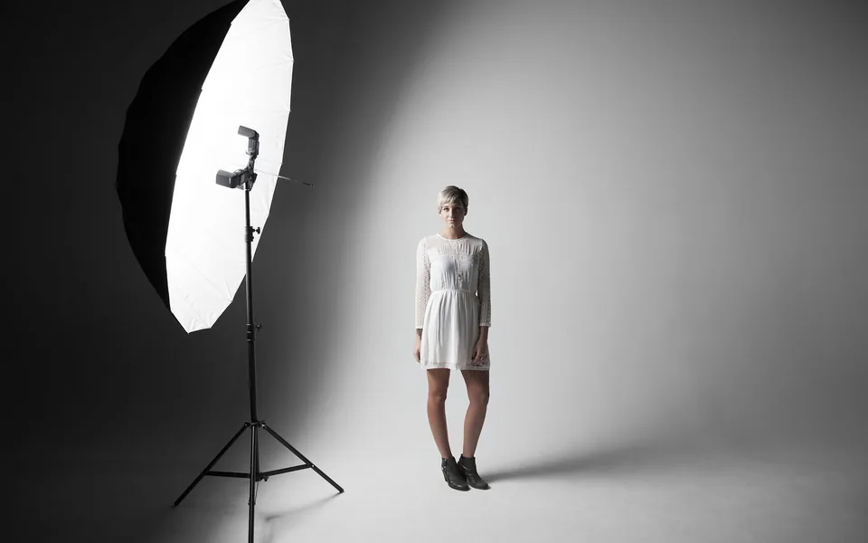 Large softbox lighting a portrait subject in a neutral studio setup
