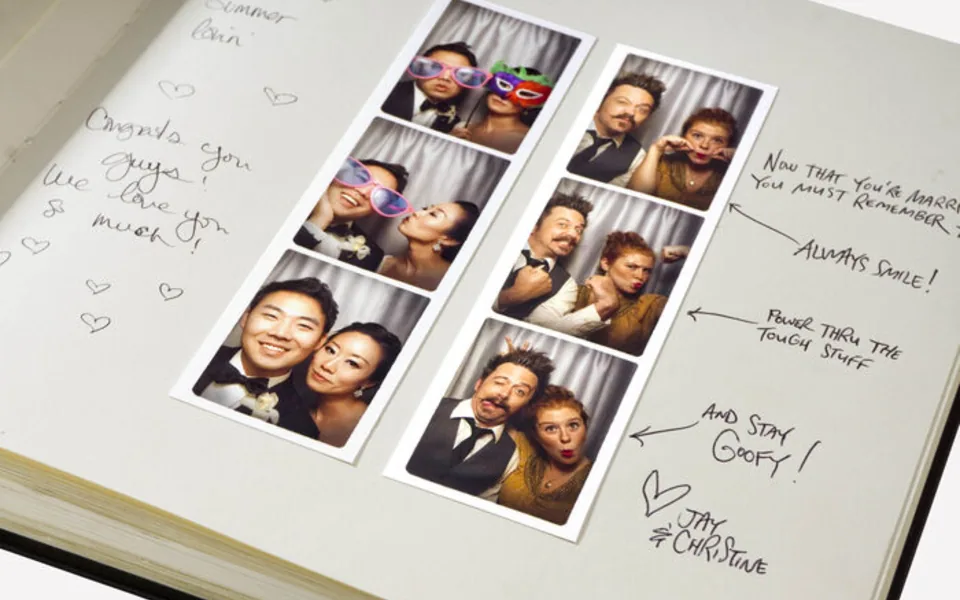 Photo booth strips pasted into a wedding guestbook with handwritten notes