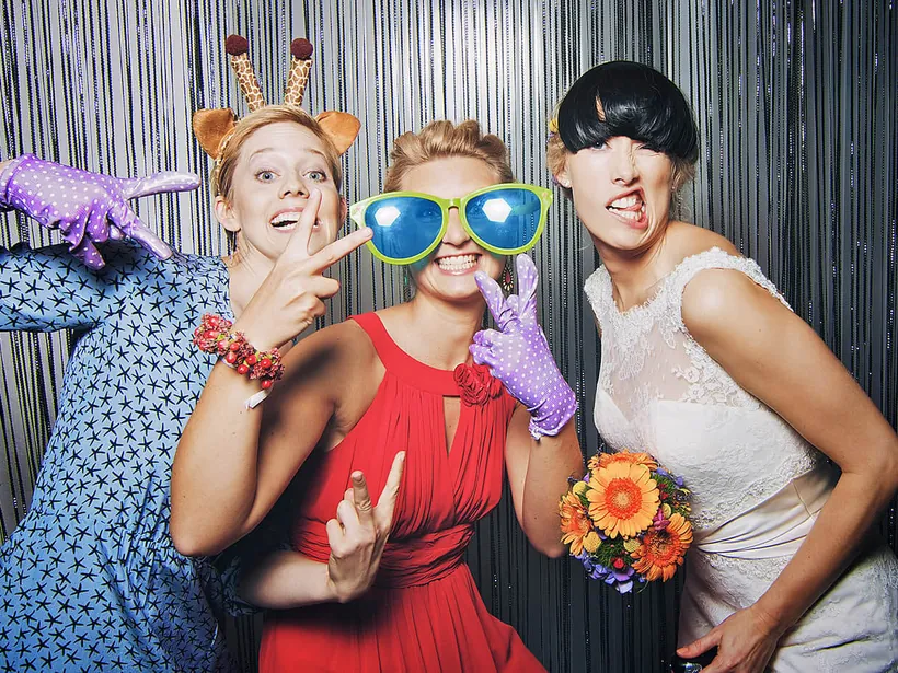 Wedding guests enjoying a StudioPic booth with props