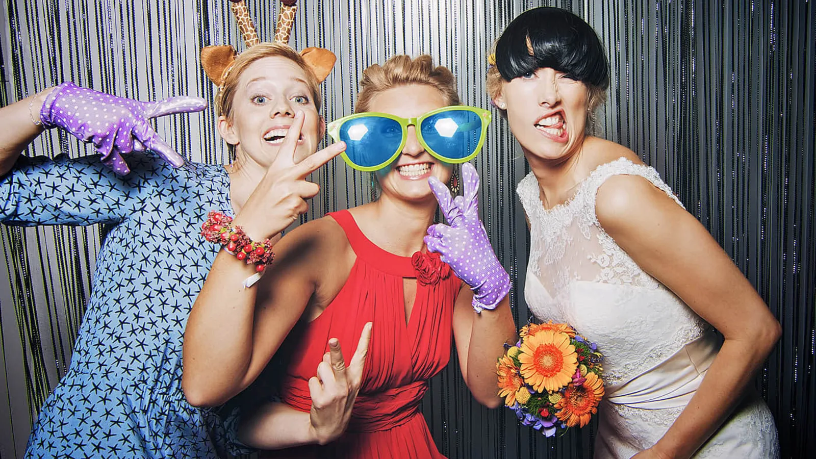 Wedding guests enjoying a StudioPic booth with props